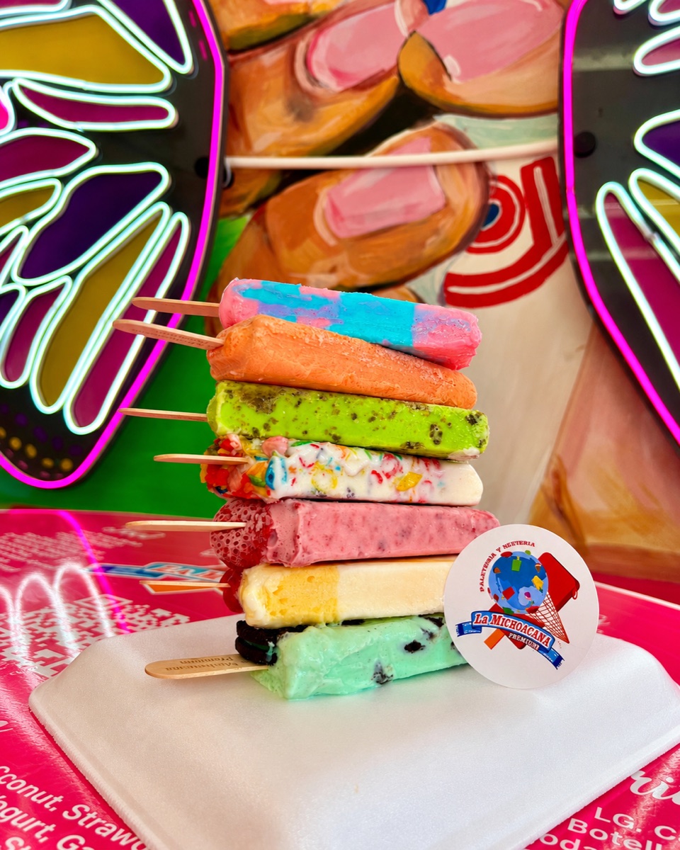 A stack of La Michoacana Premium paletas in assorted colors and flavors.